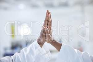 Closeup of two unknown african american medical scientists using hand gestures and giving each other a high five in a laboratory. Team of black healthcare professionals united and achieving together