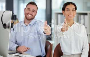 100 customer satisfaction guaranteed. a young man and woman showing thumbs up while working in a call centre.