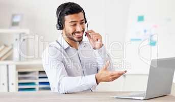 Businessman working in a call center. Customer service agent talking to a customer. Sales rep wearing a headset using a laptop. IT assistant giving advice. Call center worker using his computer