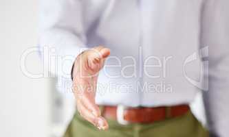 Closeup of one business man extending hand forward to greet and welcome with handshake. Networking and meeting for interview to agree on deal or offer. Collaborating on negotiation for job promotion