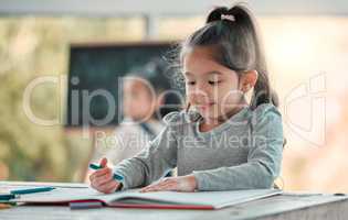 Im drawing a picture of my family. an adorable little girl doing artwork at a table.