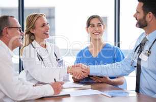 another member joining the team. Shot of two doctors shaking hands in a meeting at a hospital.