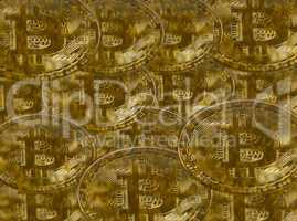 Modern gold. Conceptual image of a bunch of bitcoin against a gold background.