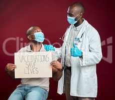 African american doctor showing thumbs up sign and symbol after covid vaccine to black man wearing face mask. Patient holding sign to promote corona vaccine and motivate after injection from physician