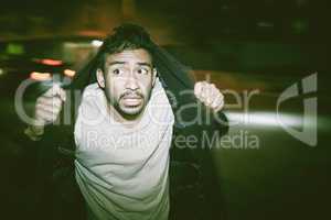 Scared man with paranoid schizophrenia and bad mental health, illness or disorder. A young guy having a hallucination from drug abuse or mental disease, running in fear at night on the street