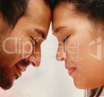 Closeup of mixed race man loving his asian wife. Headshot of hispanic couple bonding and sharing an intimate moment at home. Beautiful woman with freckles feeling in love with boyfriend