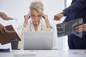 I need a way out of this stressful situation. Shot of a mature businesswoman looking stressed out in a demanding office environment.