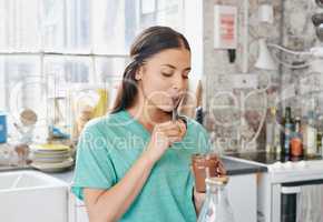 This is so worth it. a young woman eating a chocolate spread from the jar.