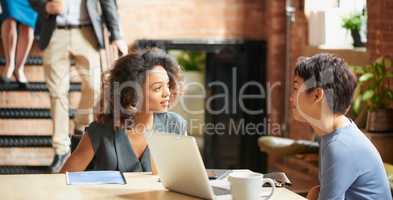What are your thoughts on this latest proposal. two businesswomen having a discussion in an office.