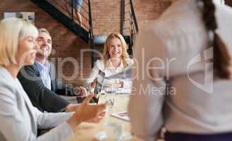 Excited to hear about all the new developments happening. a young businesswoman having a meeting with her colleagues in an office.