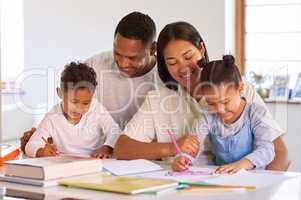 Happy little kids studying and doing homework with their parents. Mixed race couple homeschooling preschool son and daughter at home. Hispanic mother and father teaching writing lesson to children