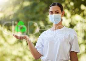 Closeup of a beautiful young woman in a mask holding copyspace showing a recycle sign. Depicting the importance of looking after the environment, going green and saving our planet. Zero waste