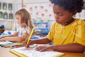 Preschool is an opportunity for growth. preschool students colouring in class.