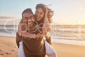 Portrait of a young diverse biracial couple having fun at the beach together