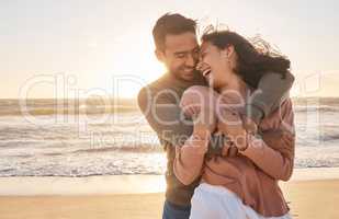 Young diverse biracial couple having fun at the beach together