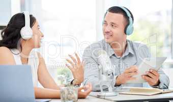 Getting to the base of a story. a young man and woman doing a broadcast in an office.