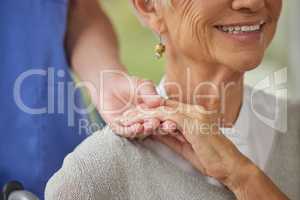 Closeup of a doctor and patient holding hands. Zoom on doctor offering a patient support during recovery. A loving doctor holding the hand of her patient and showing kindness while doing a checkup