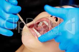 A beautiful smile begins now. a young woman having a dental procedure performed on her.