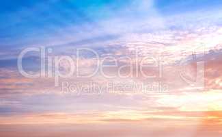 Copy space and beautiful sunset sky with wispy clouds and sun rays shining through vibrant colour with heaven and religious theory. Scenic view of peaceful, calm and serene atmosphere and ozone layer