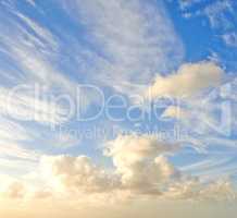 Cumulus cloud with sun shining on it. Beautiful scenery of the heavens and atmosphere with fluffy clouds, sunlight and flare. Cloudscape copy space of a bright sky on a sunny summer day from below