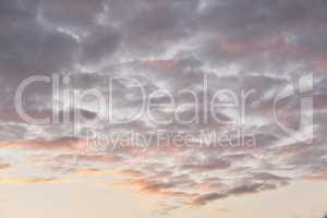 Copy space of altocumulus clouds in a moody sky at twilight. Scenic panoramic of a dramatic cloudscape and thunderous background at sunrise or sunset. Climate of gloomy dark weather at dawn outdoors