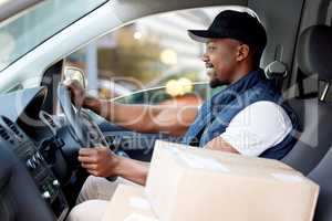 We deliver to your doorstep. Shot of young man delivering a package while sitting in a vehicle.