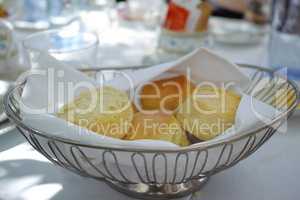 Fresh baked scones on a kitchen table at a party or event. A serving of a fresh homemade sweet snacks ready to be eaten at a family lunch. Prepared cakes for guests at a lunch date or function