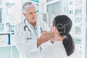 Your allergies seem to be acting up. Shot of a doctor checking a patients glands for swelling.