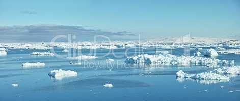 Beautiful landscape of the sea with ice on a cold winter day with a blue sky with copy space. Small iceberg in the ocean outdoors in nature in the North Atlantic with copyspace