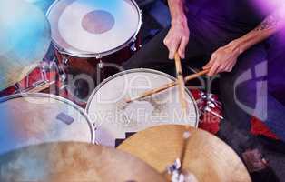Drums always get the crowd going. High angle shot of an unrecognizable male drummer performing on stage.