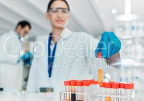 Undertaking a new controlled trial. Closeup shot of an unrecognisable scientist working with samples in a lab.