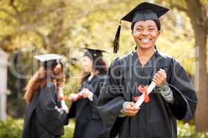 Im excited to celebrate this day with my peers. Portrait of a young woman holding her diploma on graduation day.