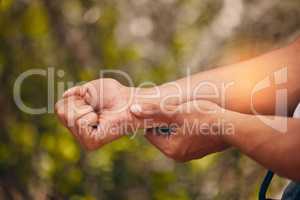 Closeup of a man suffering with wrist pain while out hiking in the woods. Superimposed CGI highlighting an injury to a young males arm while exercising outdoors in the forest