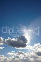 Clouds. Copyspace scenic view of a blue cloudy sky with sun shining through. Low landscape view of a cumulus cloud blocking the sun on a sunny day. Beautiful scenery of heavenly clouds with sunlight.