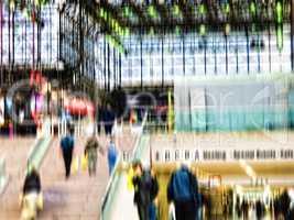 Busy scene with lots of people in blurry motion in Manhattan, New York. Men and woman walking out of a mall after shopping and doing daily routine tasks. Strangers walking up steps in a city