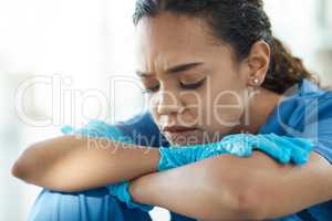 Hardships often prepare people for an extraordinary destiny. a female nurse looking stressed while sitting in a hospital.