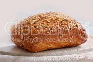 Food stuff. Closeup of freshly baked bread on a kitchen counter with copy space. Homemade wheat loaf ready to be sliced and served as a meal. Macro details of a seeded bun made fresh in a bakery.