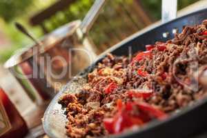 A delicious healthy meal with cooked beef meat and pepper vegetables. Flavorful recipe for a juicy dish served for dinner at a restaurant. Texture detail of tasty homemade food in a pan on a table