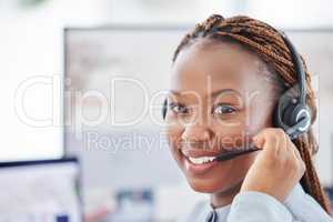 Portrait of happy smiling african american call centre telemarketing agent talking on headset in office. Face of confident friendly businesswoman operating helpdesk for customer service sales support