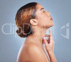 Unleash your inner beauty. a young woman standing against a grey background.