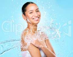 Your skin is your largest organ, do some good for it. Studio shot of clean water splashing against a woman.