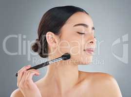 The queen of contour. an attractive young woman posing in studio against a grey background.