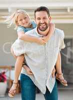 Happy single father giving his little daughter a piggyback ride outside in the garden. Smiling caucasian single parent bonding with his adorable child in the backyard. Playful kid enjoying free time