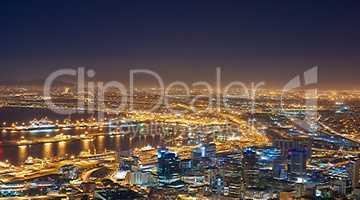 Landscape of night city lights in Cape Town, South Africa with copy space. Night cityscape of a modern vacation or holiday destination. A bright and vibrant urban skyline at sunset