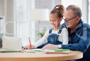 Grandpa always knows the answers. a grandfather helping his grandchild with her homework at home.