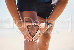 This is where I feel discomfort. a man experiencing discomfort in his knee while out for a workout.