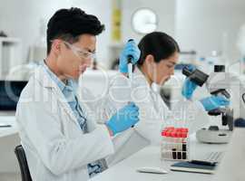 Time to send this off to the lab. Shot of a young man filling a test tube in a lab.
