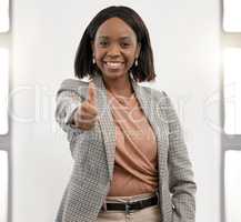 Success is often a product of your thoughts and beliefs. a young businesswoman showing thumbs up in an office.