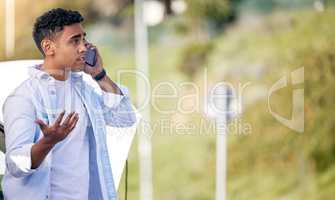 So, how long. Cropped shot of a handsome young man on the phone with roadside assistance after suffering a vehicle breakdown.