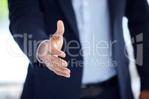 Closeup of one business man extending hand forward to greet and welcome with handshake. Networking and meeting for interview to agree on deal or offer. Collaborating on negotiation for job promotion